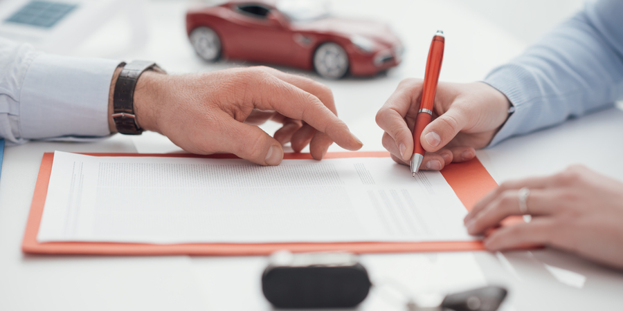 agent and customer signing an auto insurance policy