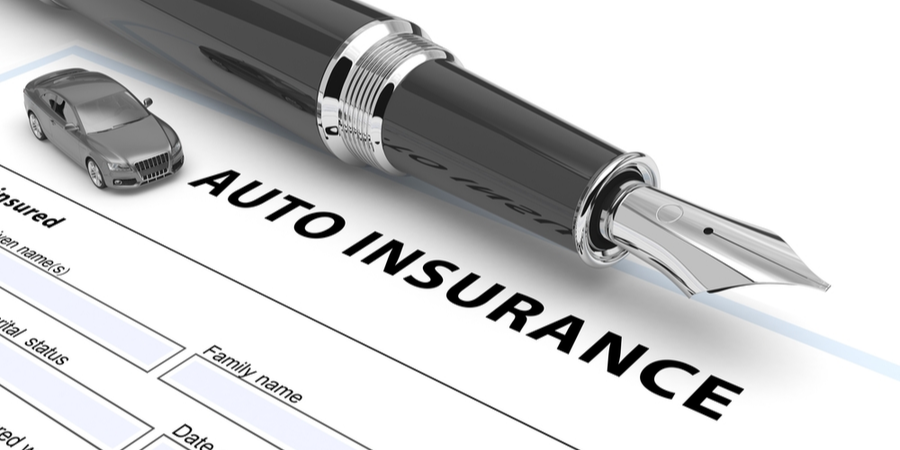 Auto insurance policy and a pen