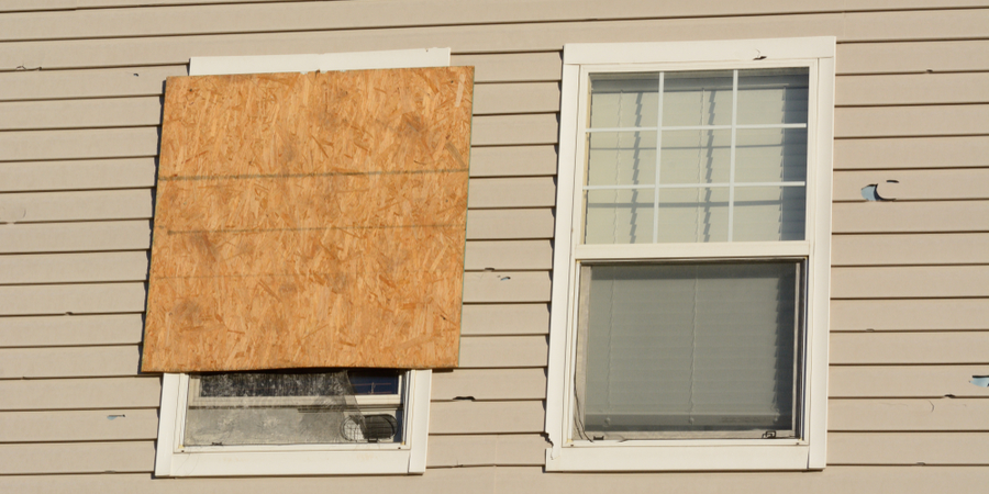 Picture of a covered window with ply wood for storm