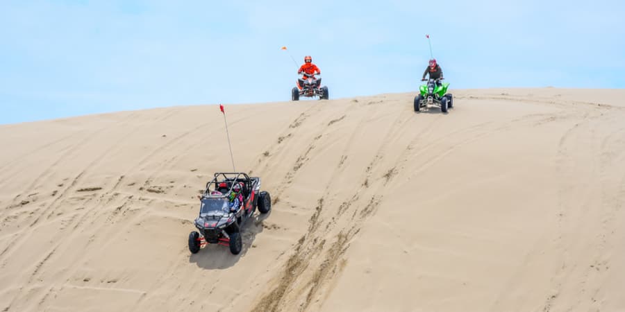 ATVs in the dunes, ATV insurance is a must to safely drive them, Contact Panorama Insurance Agency for more information.