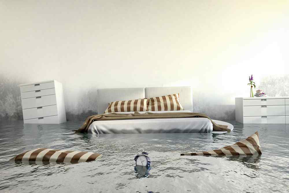 Flooded bedroom due to a burst pipe water at bed level floating items