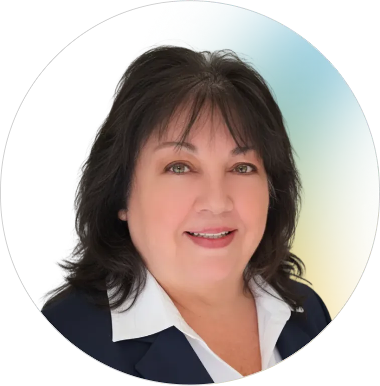 A professional headshot of a smiling brunette woman in a navy blazer and white shirt, representing the reliable leadership at Panorama.
