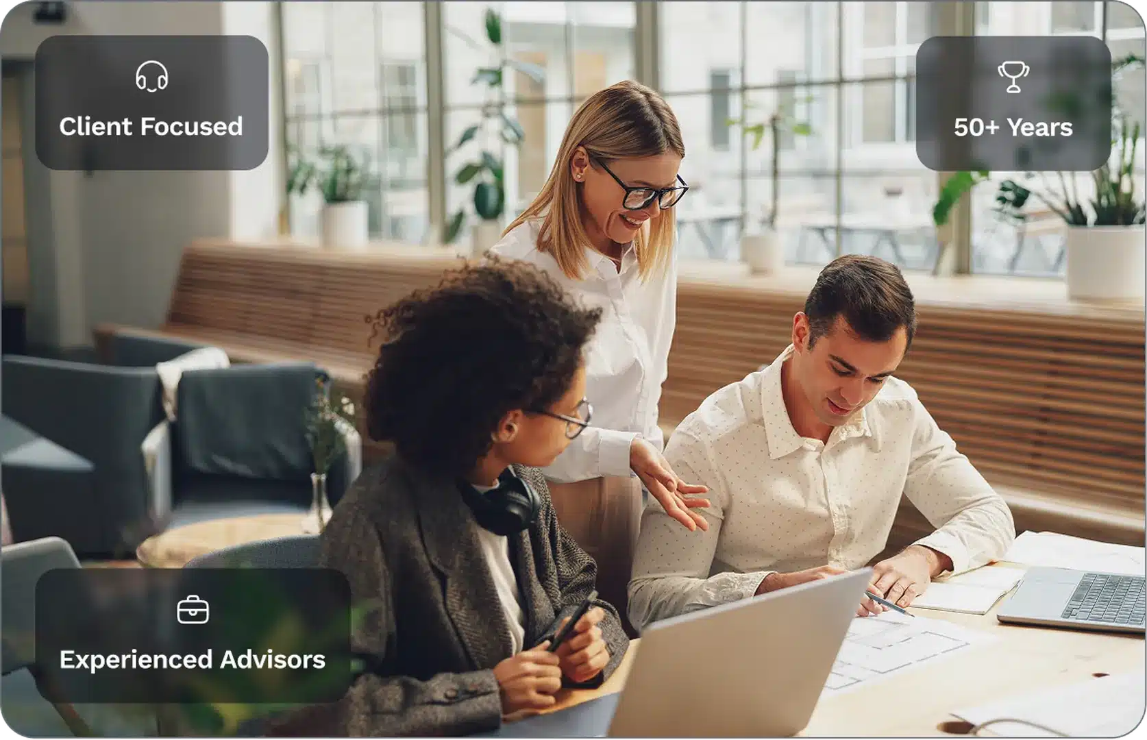 Two experienced insurance professionals—a woman in a grey blazer and a man in a mauve sweater—collaborate over a document in an office setting, featuring brand badges for 'Reliable Service' and 'Insurance Experts.'