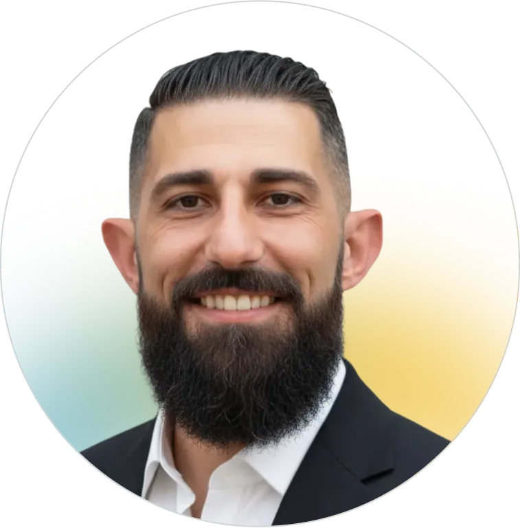 A professional headshot of a smiling man with a dark beard and groomed hair, representing the experienced and dedicated advisory team at Panorama Insurance.