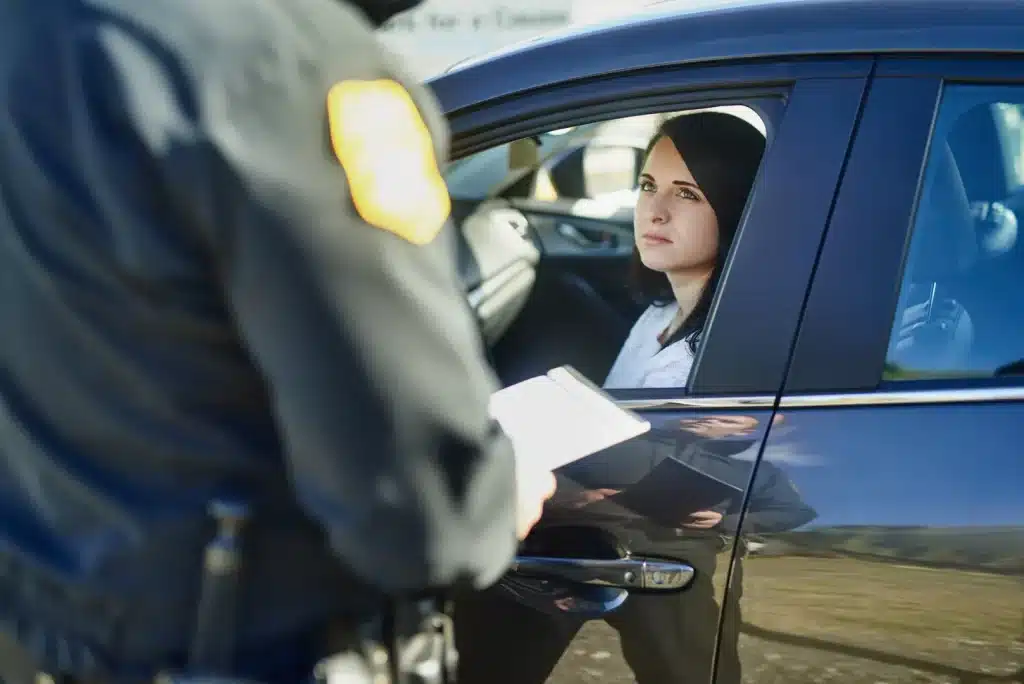 Police officer speaking to driver during roadside traffic stop